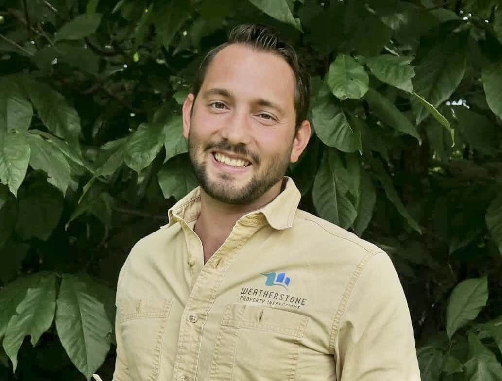 Zach Haigh Zach Haigh headshot in front of a bush